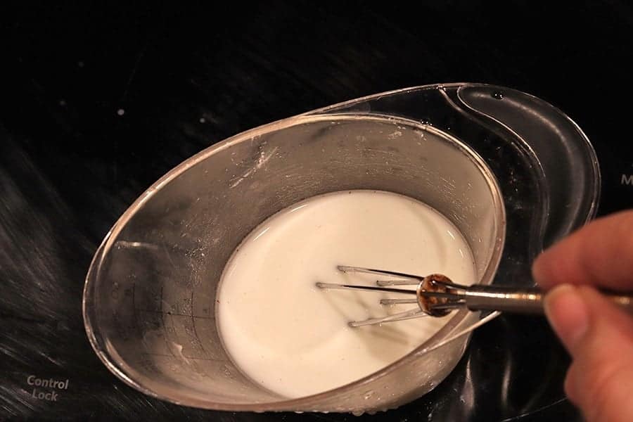 whisking cold water and cornstarch to make a slurry for making gravy