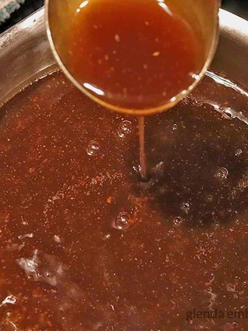 roast beef gravy being ladled out of a pan - condiments - dips- gravies -sauces