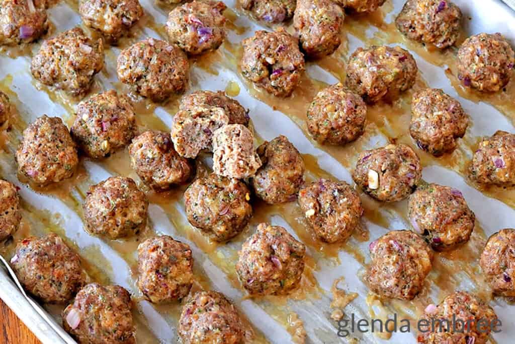 baked meatballs  on parchment lined baking sheets