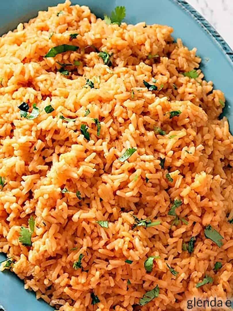 Mexican rice in a blue stoneware bowl.