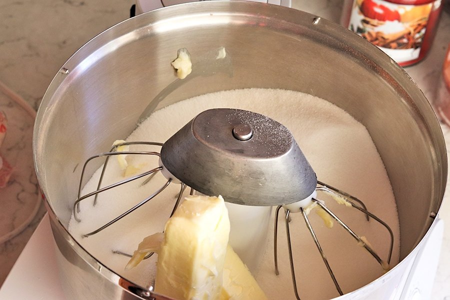 Butter and sugar in the bowl of a stand mixer, ready to be creamed to make a chocolate cake batter.