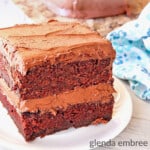 Homemade Chocolate Cake slice on an ivory stoneware plate with a blue print fabric napkin alongside