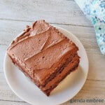 Homemade Chocolate Cake with Fudge Frosting on a white plate