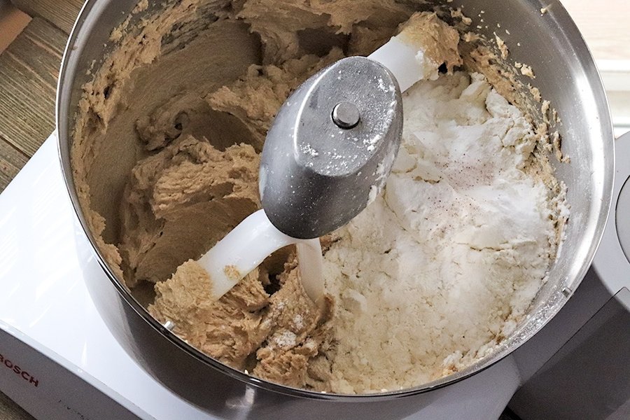 adding dry ingredients to mixing bowl