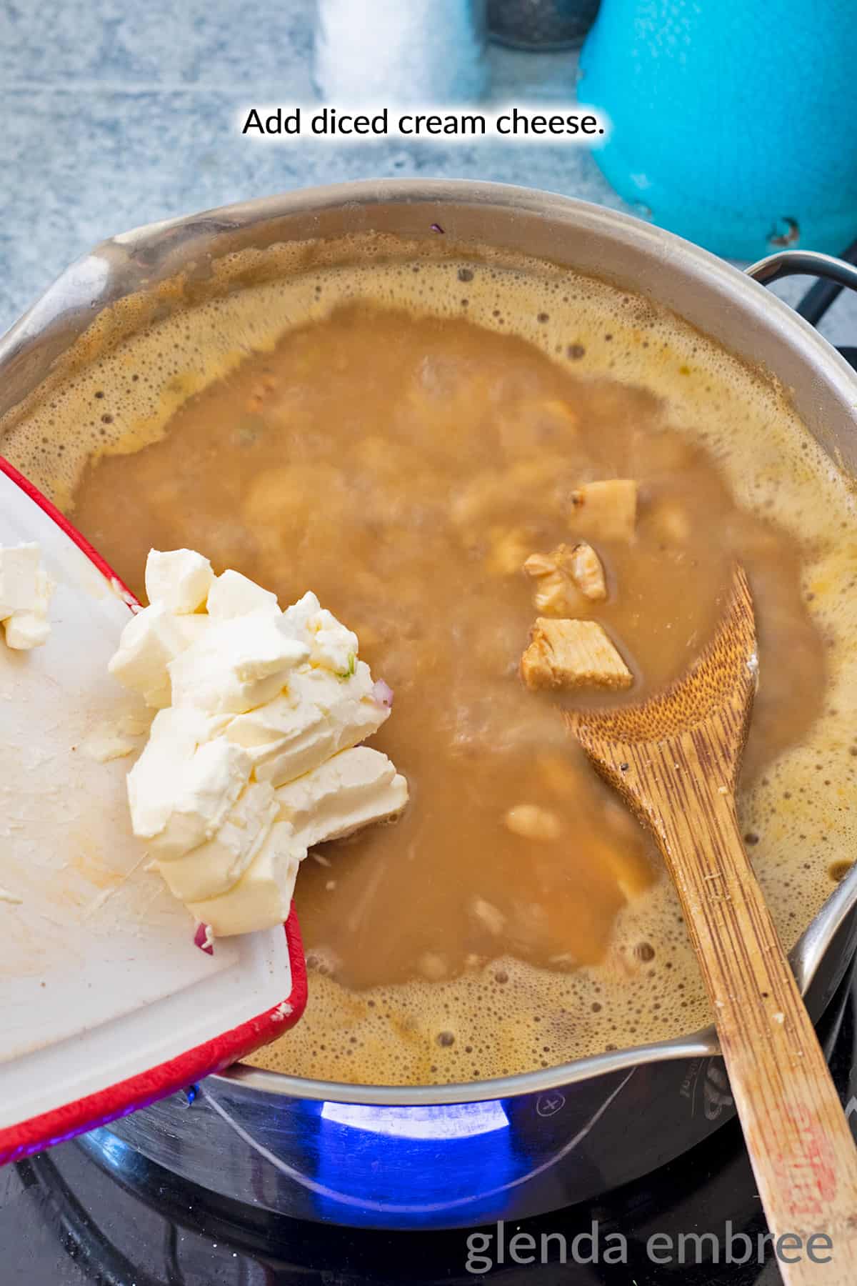 Adding cream cheese to pot of whte chicken chili