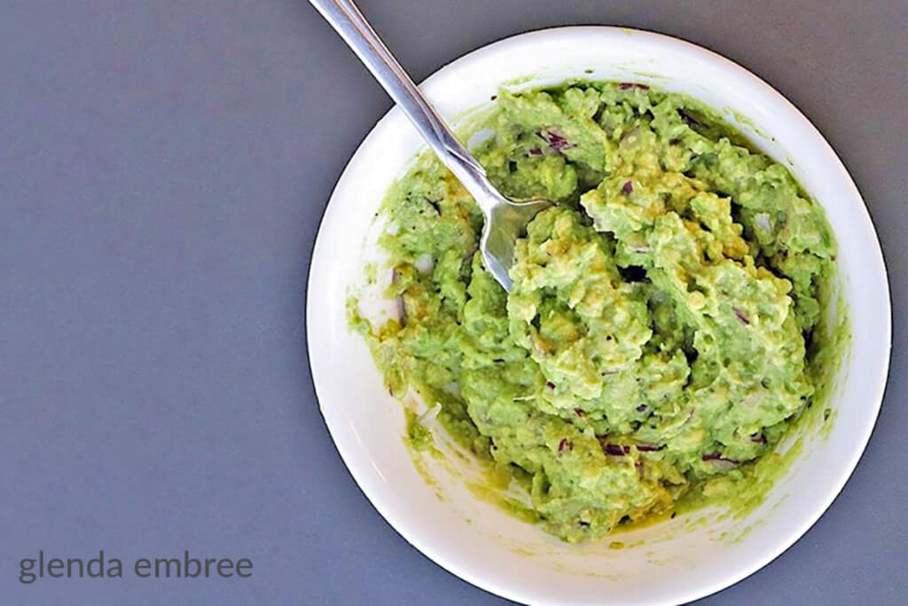 homemade guacamole in a white bowl