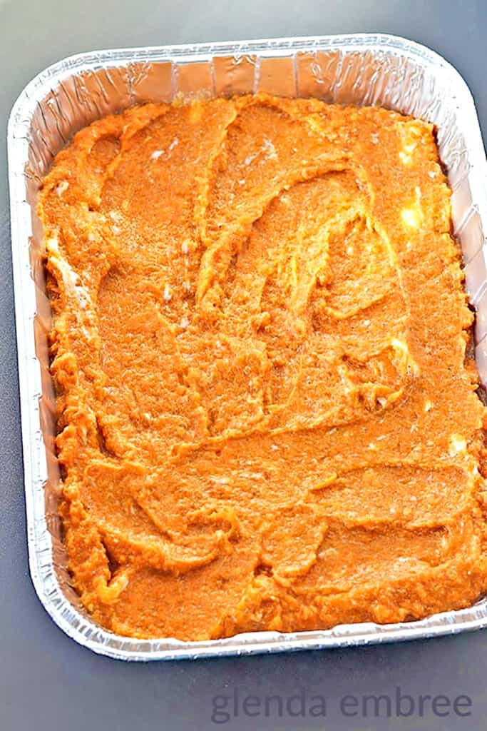 Sweet Potato Casserole mixture spread in a 9x13 foil baking pan