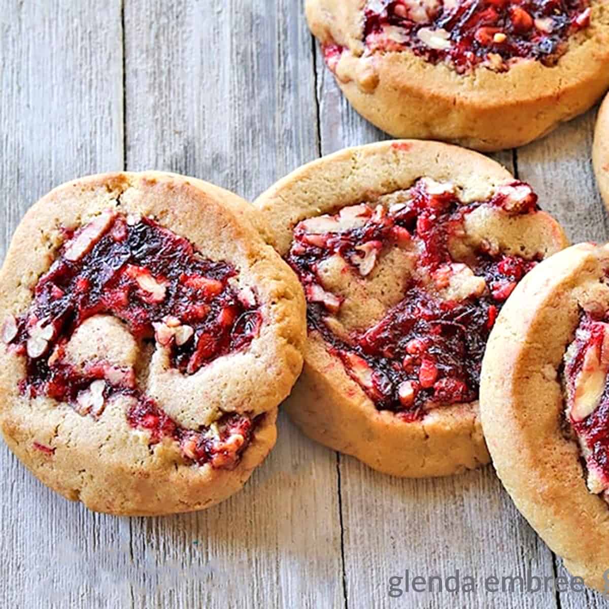 Cranberry Pecan Pinwheel Cookies (Filled Cookies) on a rough wooden table top