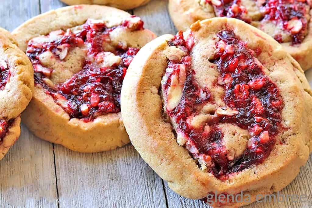 Cranberry Pecan Pinwheel Cookies (Filled Cookies) on a rough wooden table top
