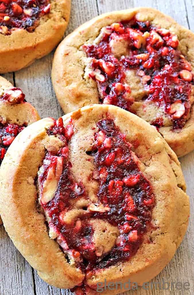 Cranberry Pecan Pinwhell Cookies (Filled Cookies) on a rough wooden table top