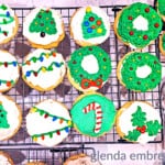 drop sugar cookies decorated and sitting on a cooling rack