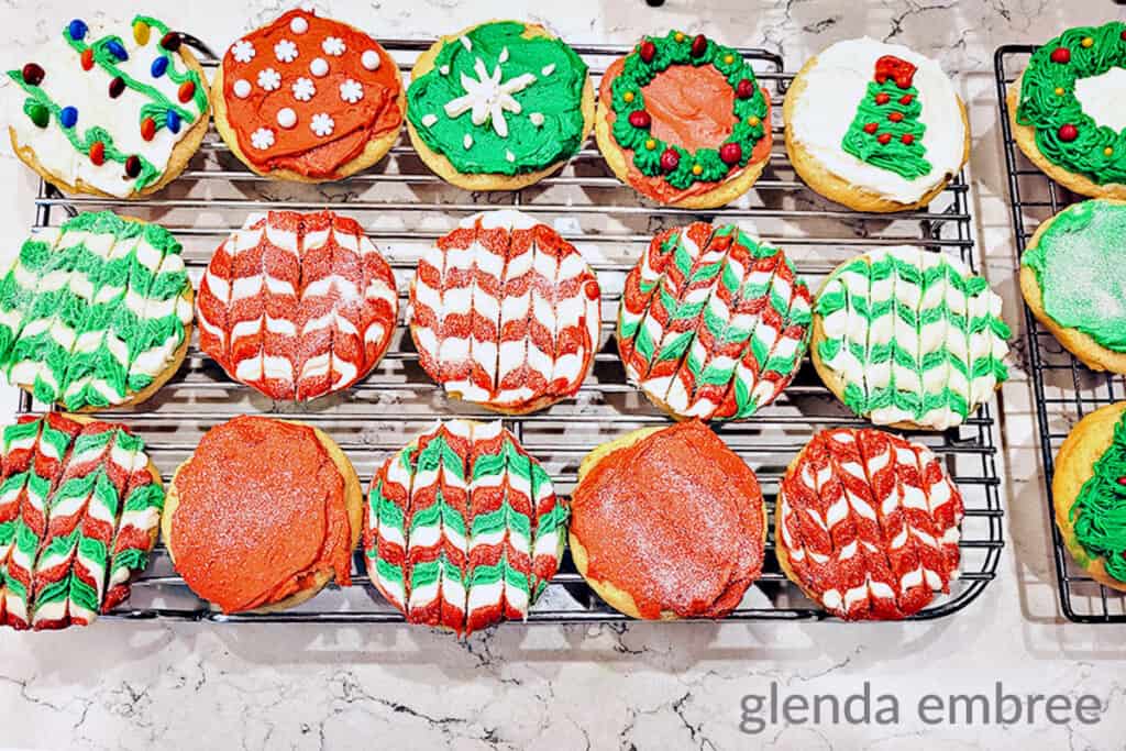 drop sugar cookies decorated and sitting on a cooling rack