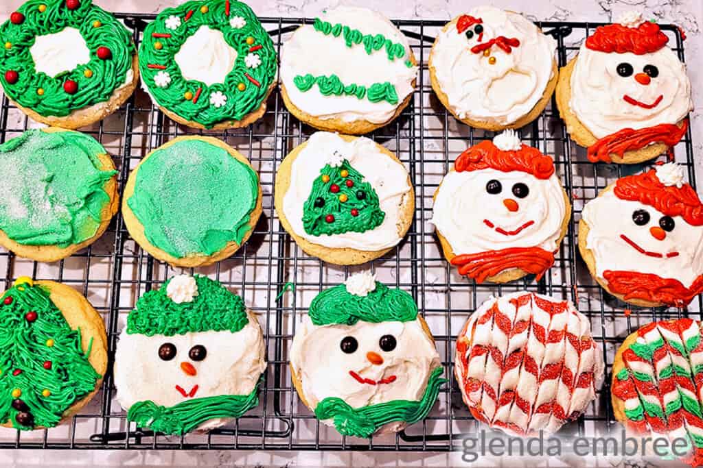 drop sugar cookies decorated and sitting on a cooling rack