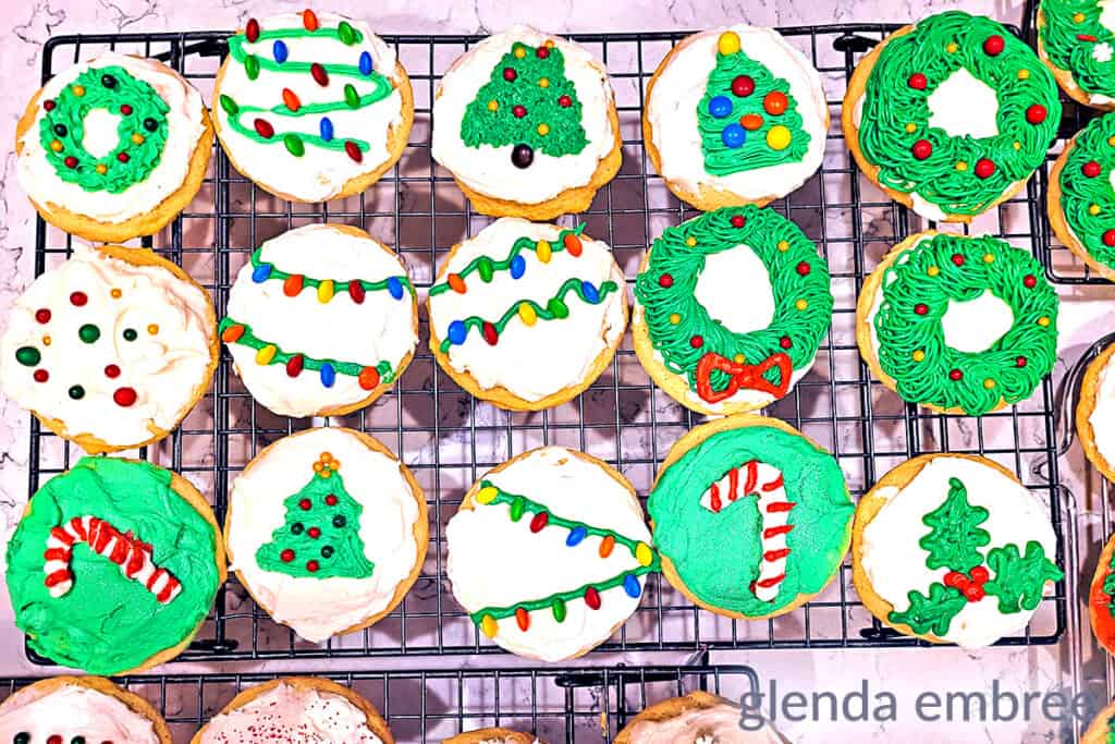 sugar cookies decorated and sitting on a cooling rack