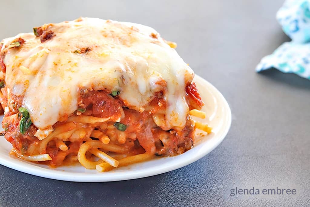 Baked spaghetti on a white plate.