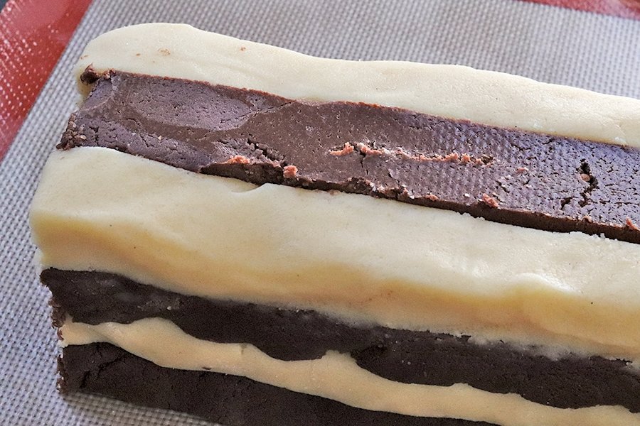 Flipping the center strip of dough to create the checkerboard pattern.