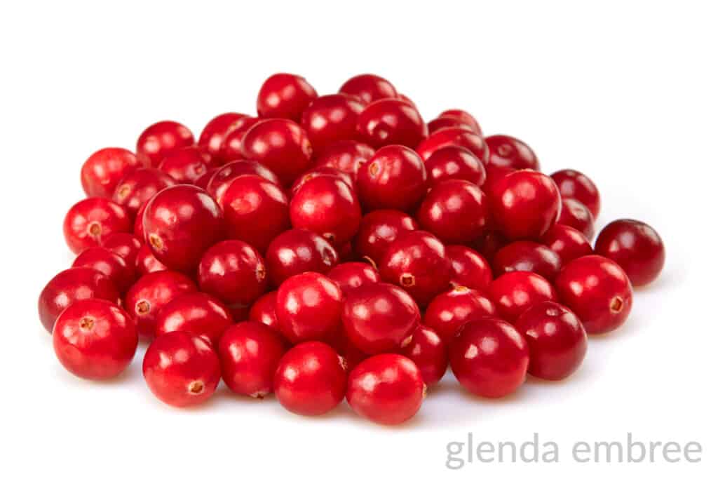 pile of fresh cranberries on a white counter top