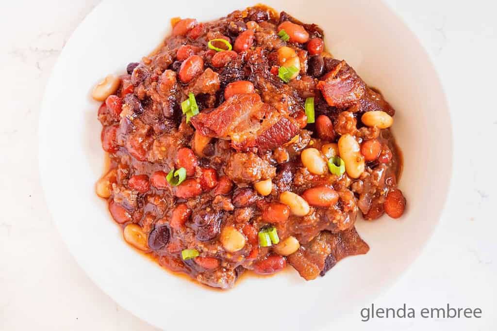 Baked Bean Casserole (Cowboy Beans aka Calico Beans or Baked Beans with Hamburger) served on a white plate.