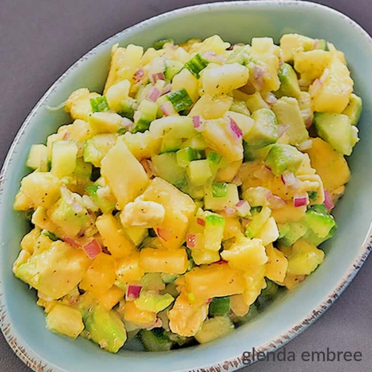 pineapple avocado salsa in a blue stoneware dish