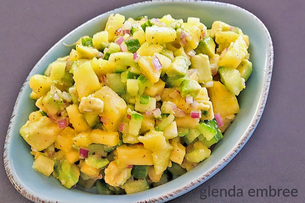 pineapple avocado salsa in a blue stoneware dish