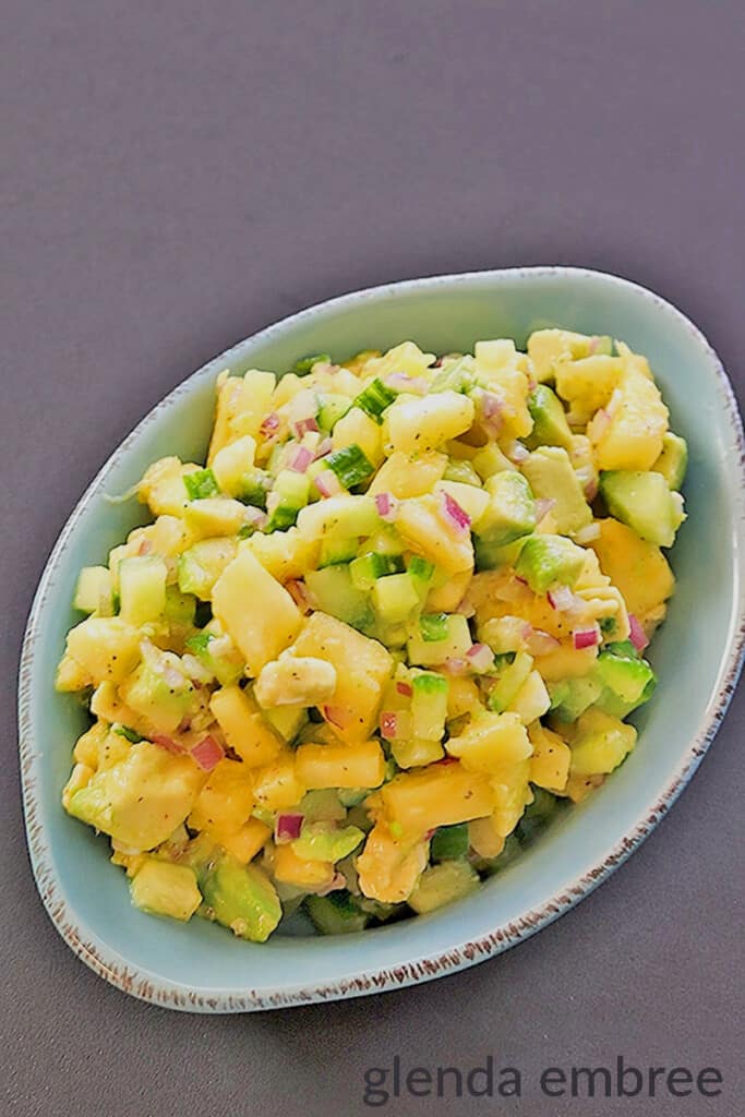 pineapple avocado salsa in a blue stoneware dish