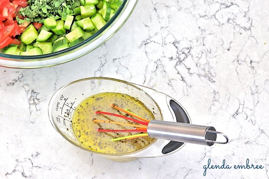 whisking together citrus dressing