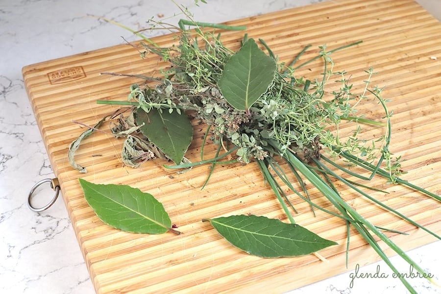 fresh herbs on a wooden cutting board