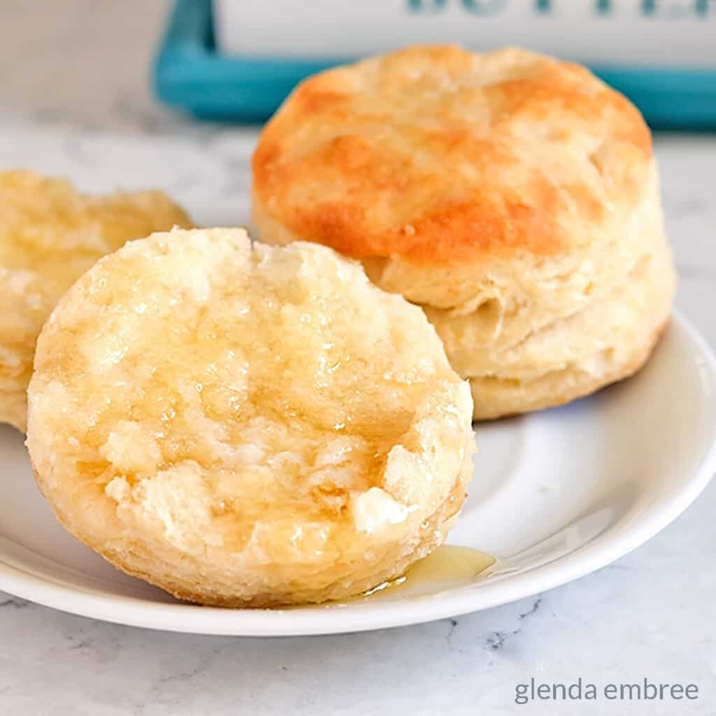 biscuits on a plate with butter and honey - bread recipes