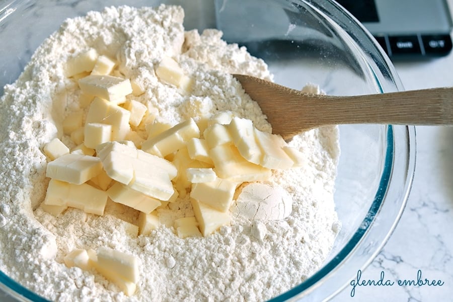 adding butter cubes to flour for making biscuits and easy homemade quick bread