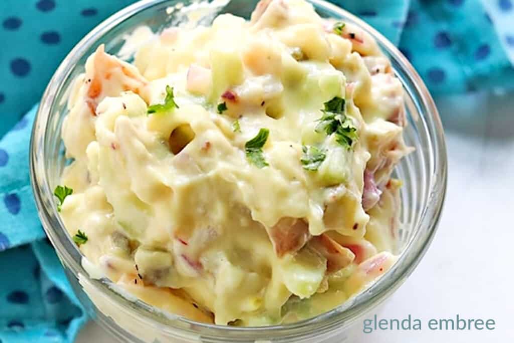 potato salad in a clear bowl with a turquoise and navy print napkin