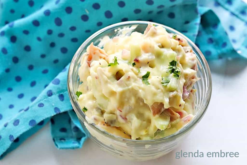 potato salad in a clear bowl with a turquoise and navy print napkin