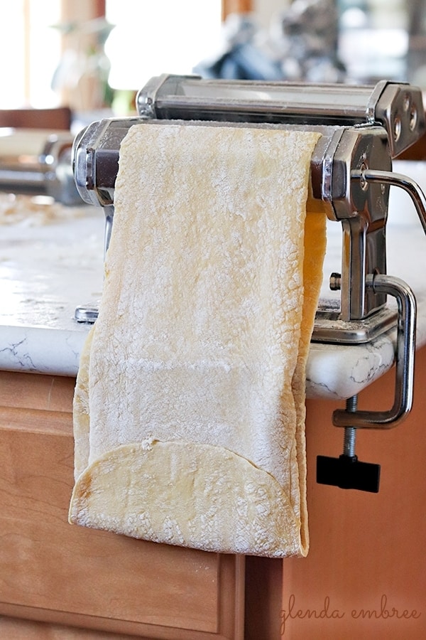 homemade pasta dough sealed in a loop on the pasta machine