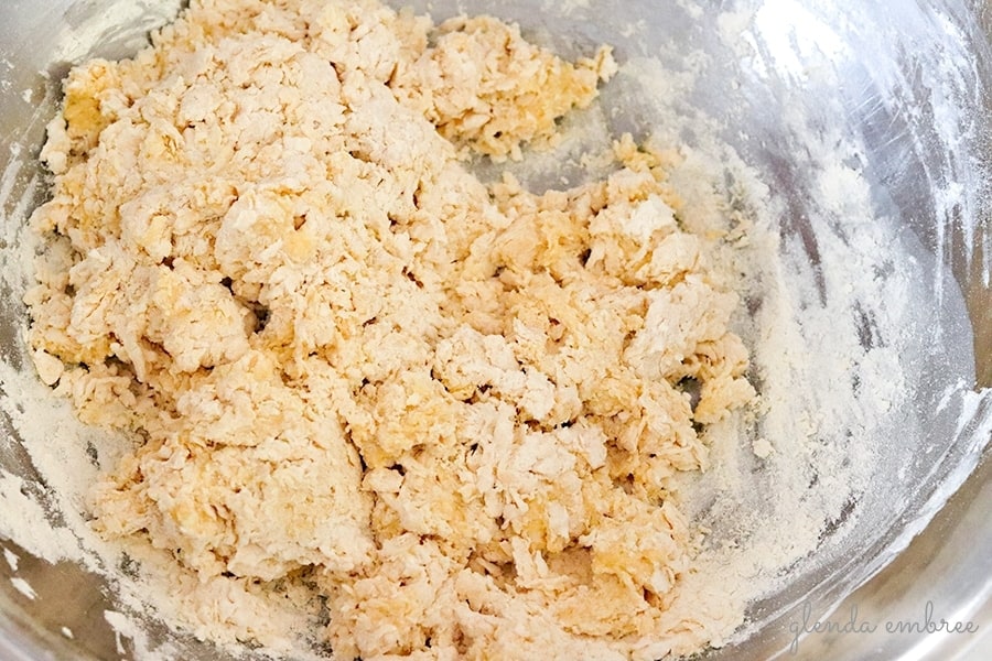 homemade pasta dough coming together in a shaggy mass