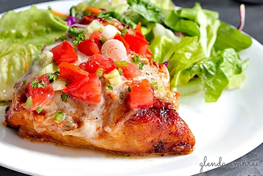 Monterey Chicken on a plate with a green salad