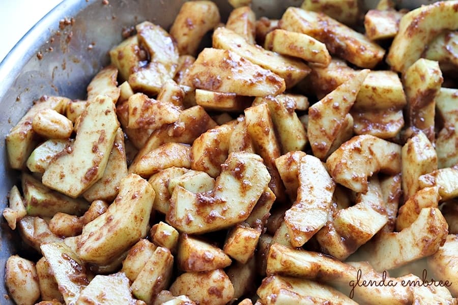 apple slices tossed in flour, sugars, cinnamon and nutmeg
