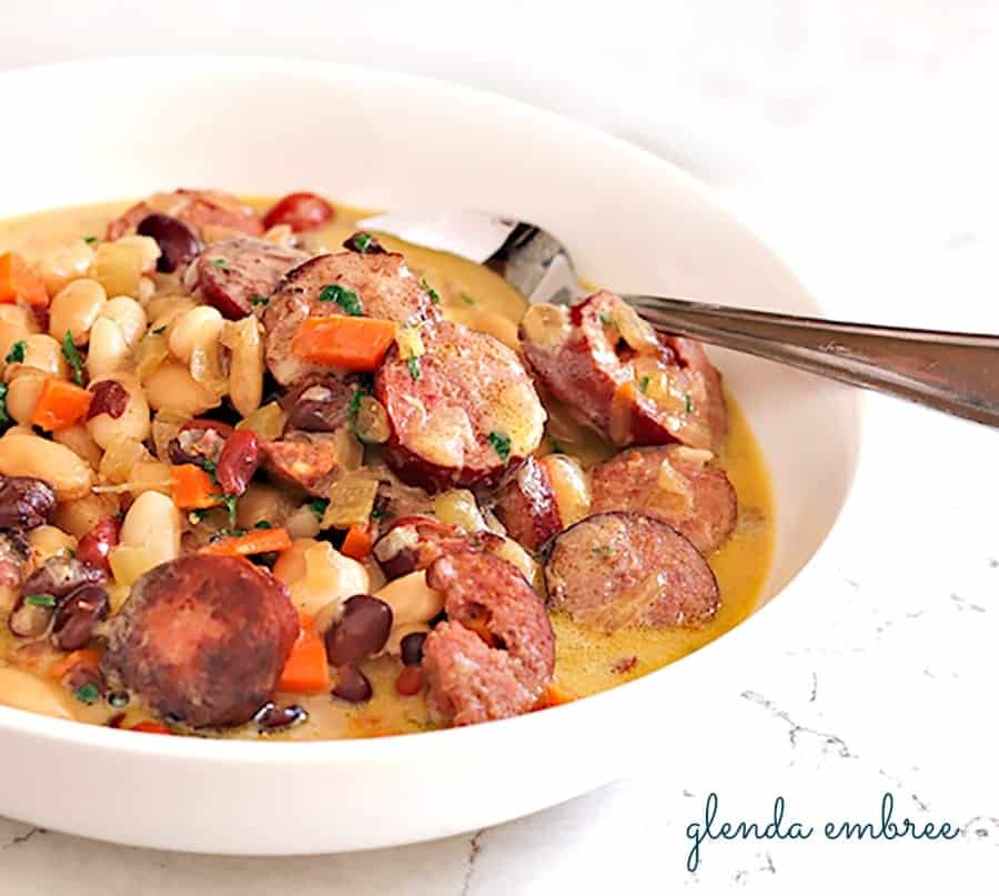 bean soup with sausage and vegetables in a bowl