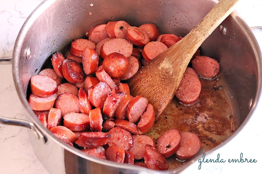 Caramelizing sausage in a pan for bean soup