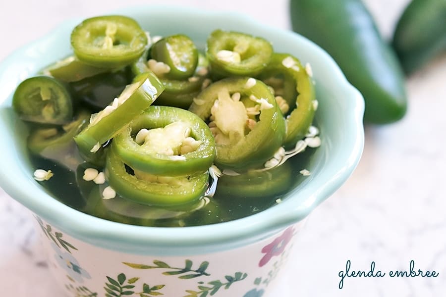 quick pickled jalapenos (quick pickled vegetables) in a decorative dish for serving - easy recipe at glendaembree.com
