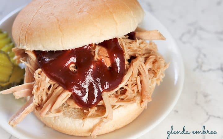 perfect pulled pork sandwich on a white plate