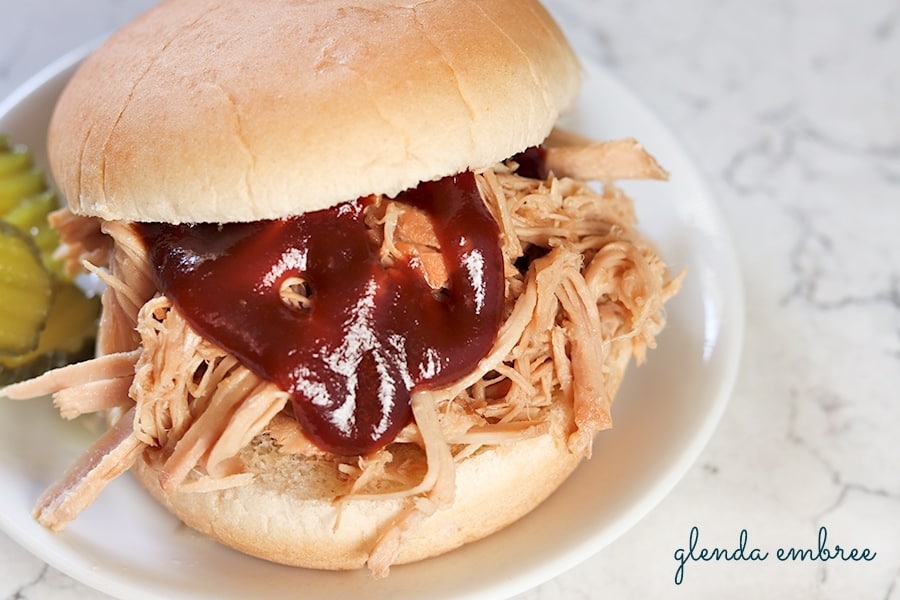 perfect pulled pork sandwich on a white plate