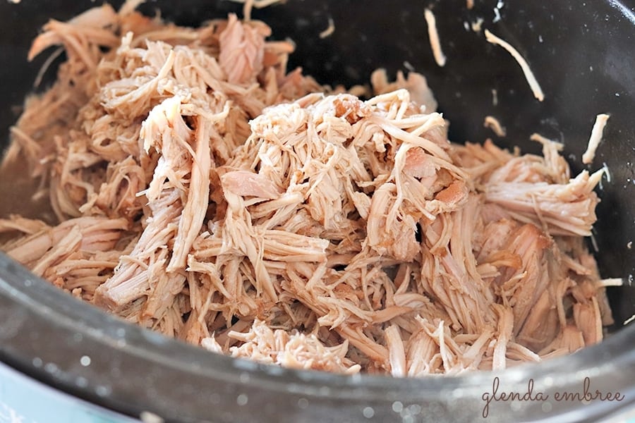 Perfect pulled pork in a slow cooker, ready to serve