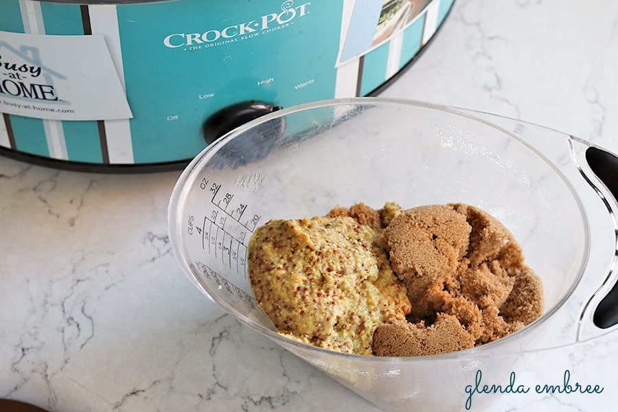 stone ground mustard and brwon sugar in a measuring cup