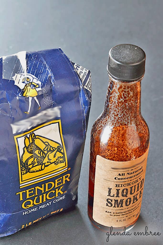Bag of Morton Quick Tender Salt next to a bottle of liquid smoke