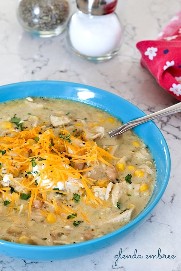 Instant Pot Poblano Chicken Chili served in a blue bowl on a marble counter