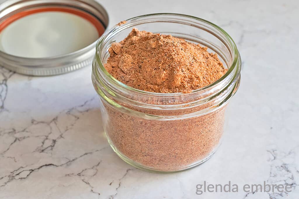 homemade all purpose seasoning in a mason jar sitting on a marble countertop