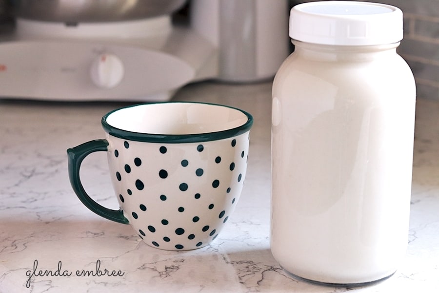 Cashew Coconut Milk in a glass bottle with a glass of Cashew Coconut Milk on the side. Fabulous dairy alternative and non-dairy blend.