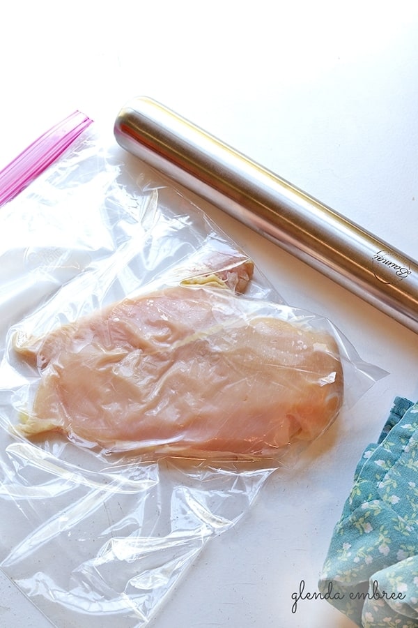 pounding chicken with rolling pin for making Perfect Baked Chicken Breasts