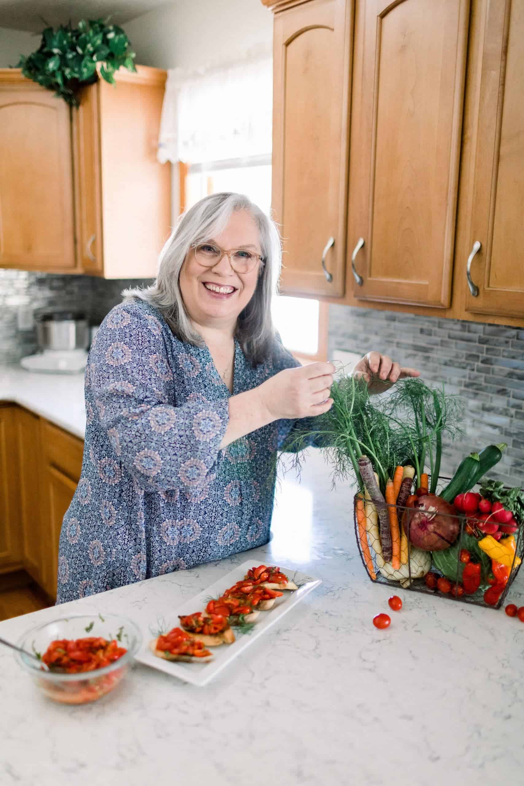 Glenda Embree making bruschetta and selecting some fennel fronds for garnish.