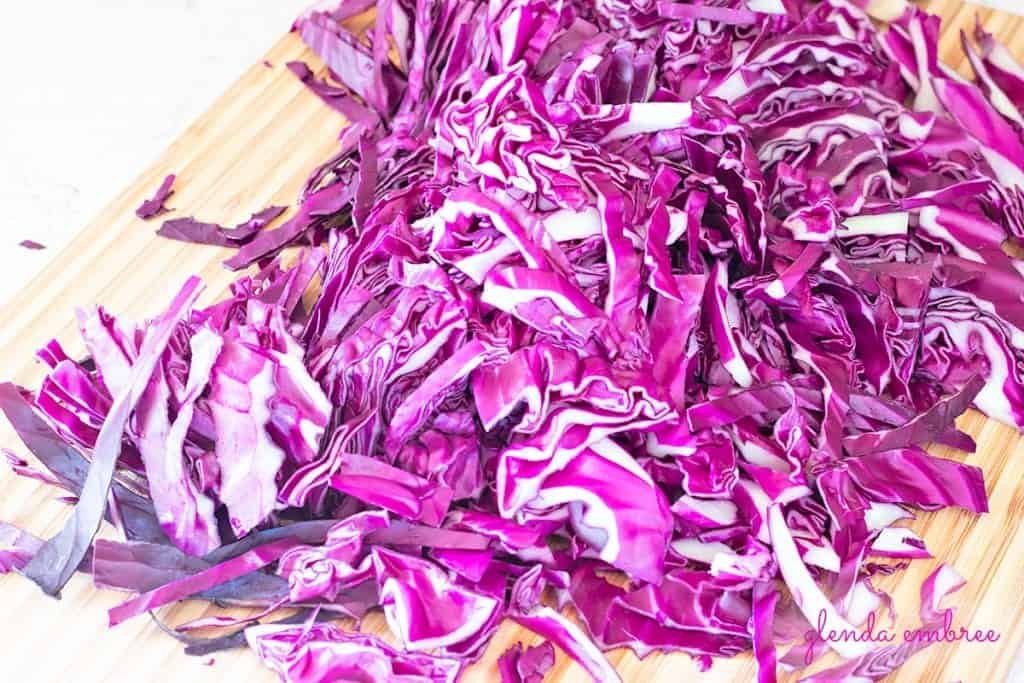 hand cut purple cabbage on a cutting board