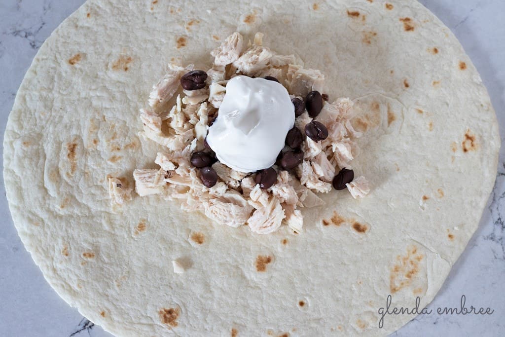 How to Assemble a Crunch Wrap: Add sour cream